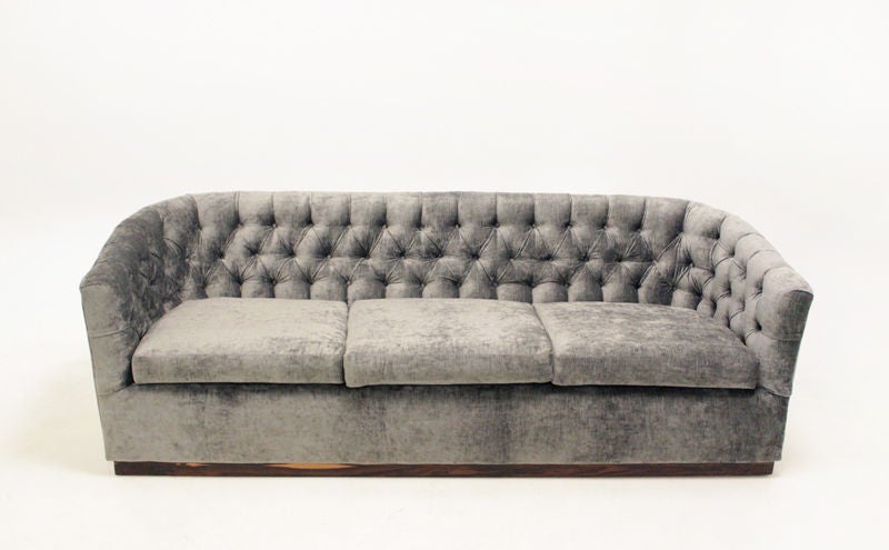 A curved button tufted silver silk velvet sofa with a plinth base finished in a beautiful sap grain rosewood.<br />
<br />
Please see this listing for matching tufted lounge chairs:<br />
http://www.1stdibs.com/furniture_item_detail.php?id=535075
