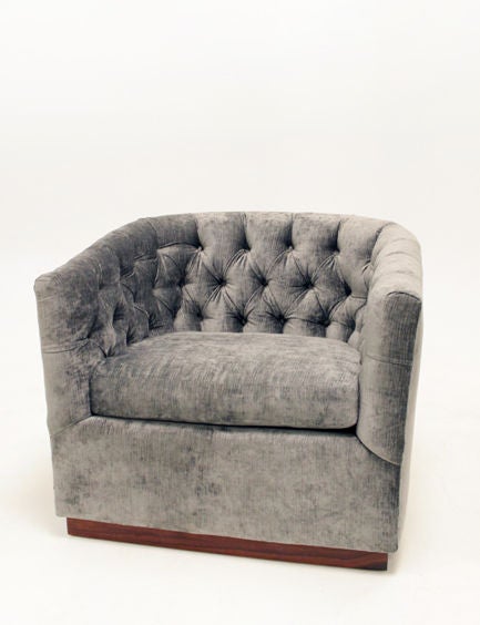 A pair of curved, button tufted, silver silk velvet lounge chairs with a plinth base finished in a beautiful sap grain rosewood.

Please see this listing for the matching sofa:
http://www.1stdibs.com/furniture_item_detail.php?id=535073