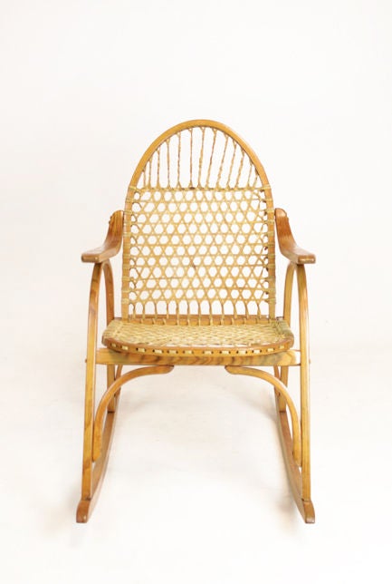A beautifully constructed oak snowshoe chair by Vermont Tubbs, one of the oldest furniture designers  in the United States. Rawhide lacing shows some wear consistent with age of piece.

Many pieces are stored in our warehouse, so please click on