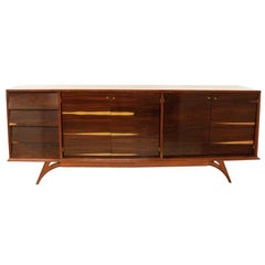 Rosewood cabinet with angled drawers and vintage brass pulls