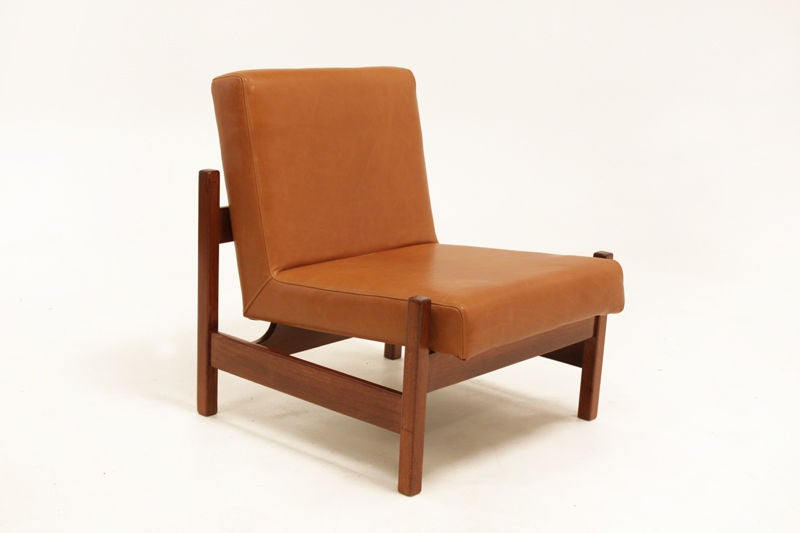 A pair of restored peroba wood chairs upholstered in a rich caramel leather. Forma distributed and produced many designs by Knoll in the 1960s. These are essentially Brazilian Knoll chairs as some of the pieces sold by Forma shared both a Forma and