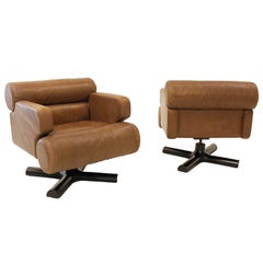 Pair of French distressed leather swivel chairs