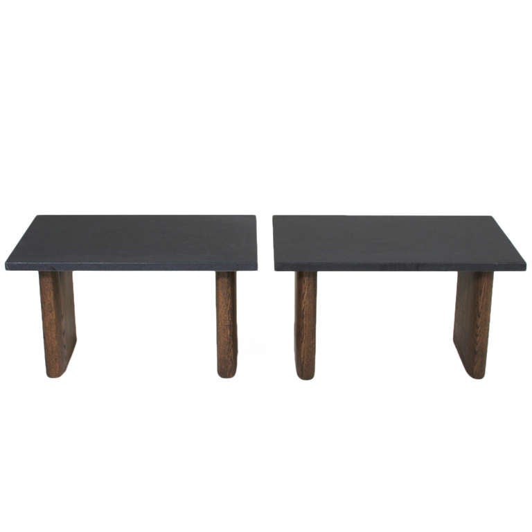 A pair of side tables in Solid Oak with a charcoal oil finish with a honed black granite top with narrow rectangular legs with rounded edges.

This item is available for custom order and the lead time is 6-8 weeks; sometimes we are able to