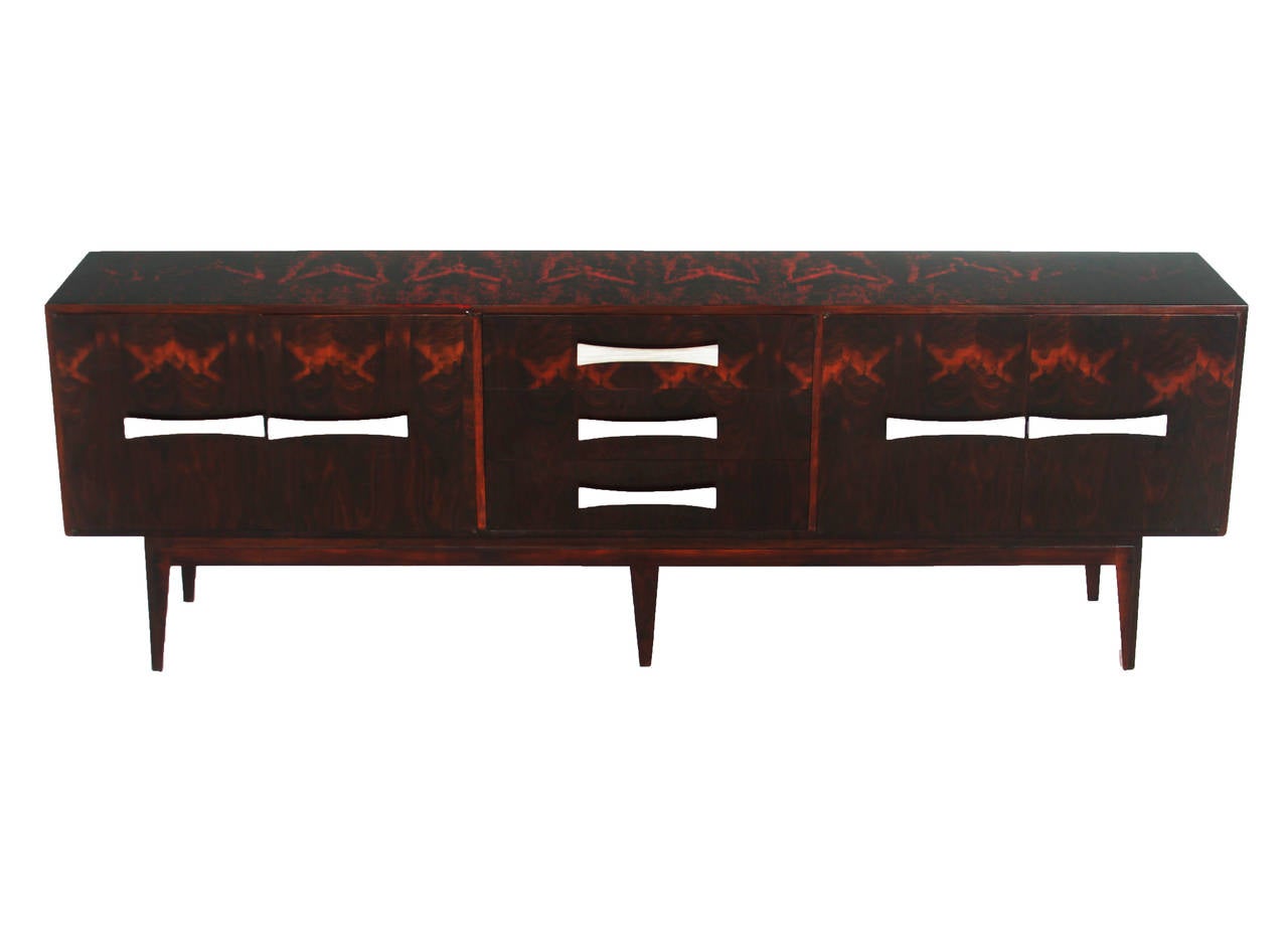 A beautiful rosewood credenza with a solid rosewood base and Blanched Oil Rosewood bow-tie handles. Beautiful sap grain with lacquered finish.

Many pieces are stored in our warehouse, so please click on CONTACT DEALER under our logo below to find