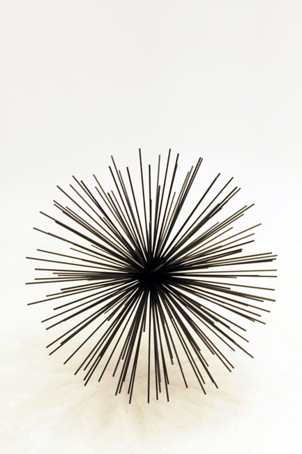 Large metal starburst wall sculpture with protruding metal rods and bronze painted finish attributed to C Jere.

In order to preserve our inventory, after restoration we blanket wrap and store nearly every piece in our warehouse.  Please email