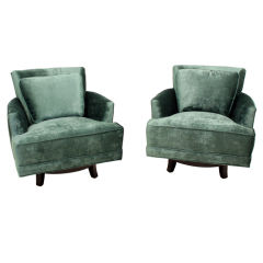 Pair of green mohair swivel chairs with pillows