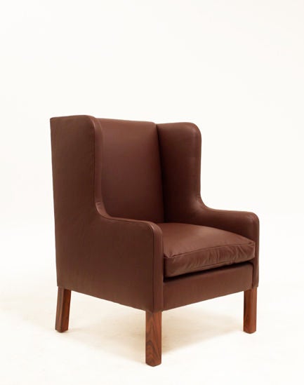 A set of three wingback arm chairs in a rich burgundy leather with rosewood legs. One has a normal back and the other two have exceptionally high backs to complement.
Seat depth measures 22