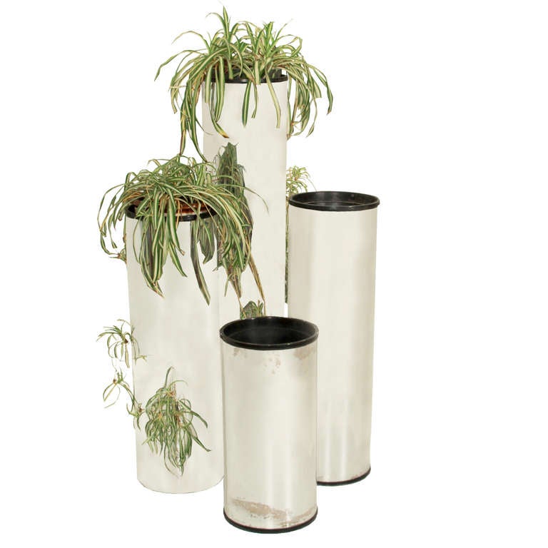 Four cylindrical chromium plated pedestal planters in varying heights.

Measures: Middle planter's height measures 33.5