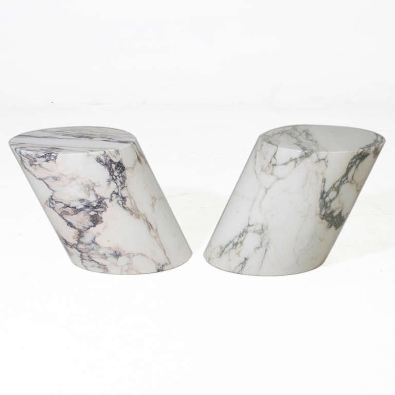 An elegant pair of Carrera marble side tables. The marble is solid throughout and in original condition. They are beautifully tilted but well balanced and a unique design. 

Many pieces are stored in our warehouse, so please click on CONTACT