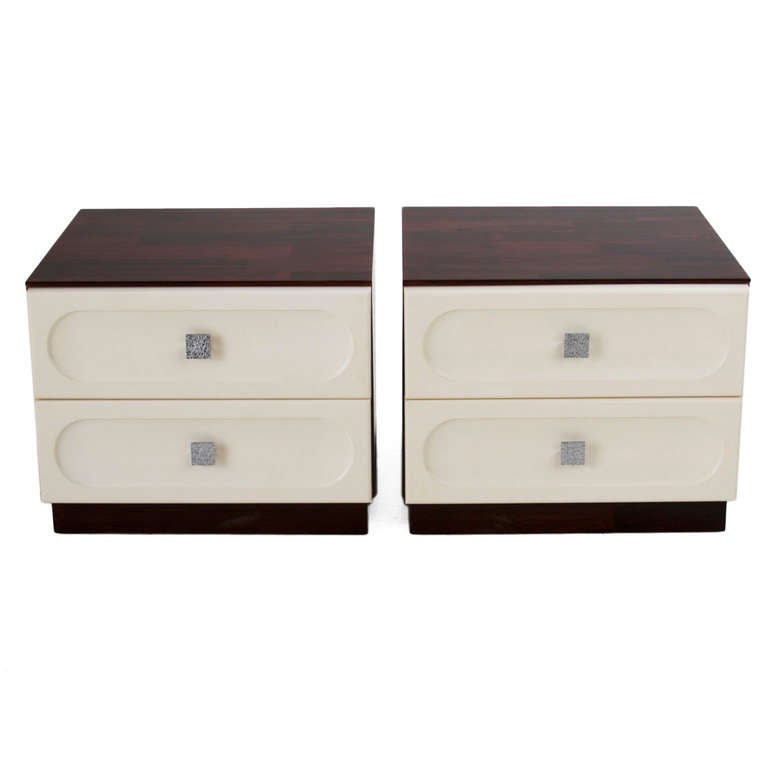 Pair of night stands in solid Rosewood with white fiberglass drawers that have a metal handle with a scattered lined detail. 

Many pieces are stored in our warehouse, so please click on CONTACT DEALER under our logo below to find out if the