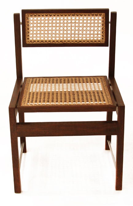 Set of six Brazilian hardwood swivel back dining chairs with caned seats and backs as well as aluminium rods along the side. Caning was redone in the last year. Each chair back swivels backwards and forwards to create adjustable