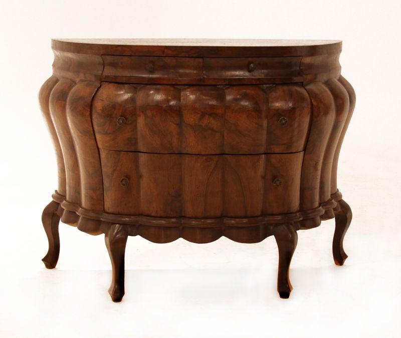 Beautiful half moon bombay chest with 4 drawers, scalloped frontage and brass hardware on top of carved base. The chest has beautiful lines and unique grain.
Many pieces are stored in our warehouse, so please give us a call at (323) 463-4434 or
