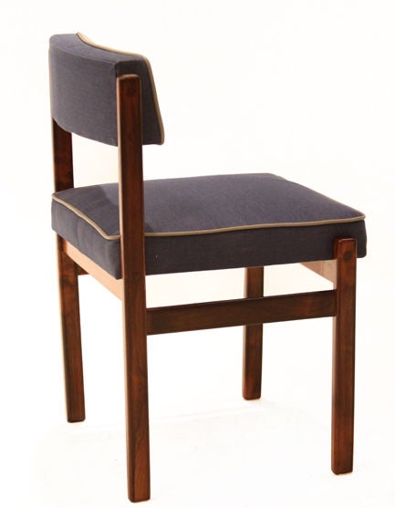 Set of 8 Rosewood dining chairs from Brazil with new blue denim upholstery and elephant gray leather piping. These chairs are sturdy and very comfortable with highest quality foam cushions. Seat Depth: 17