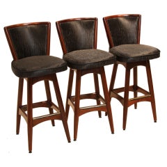 Set of three Walnut swivel bar stools with sharkskin vinyl