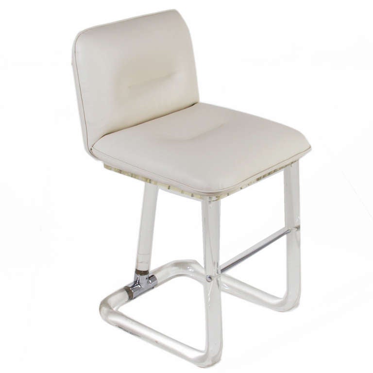 A sleek set of 5 swiveling bar stools in white line tufted vinyl with a clear fiberglass base with chrome accents.

Seat depth measures 16