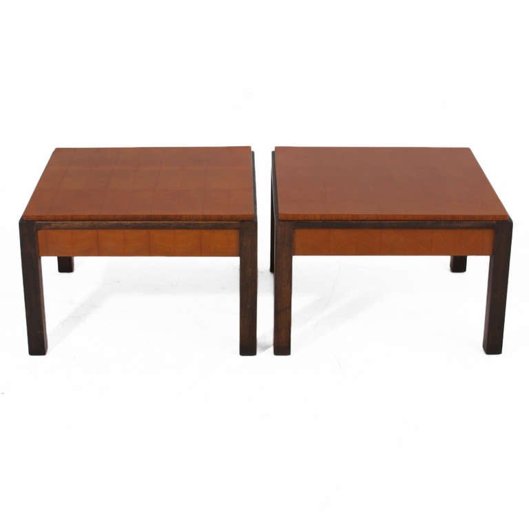 A beautiful pair of side tables by Metropolitan furniture company. The legs are Ebonized Mahogany that extend to line the side of the table. The top is solid oak end grain parquetry and has a thick piano finish. 

Many pieces are stored in our