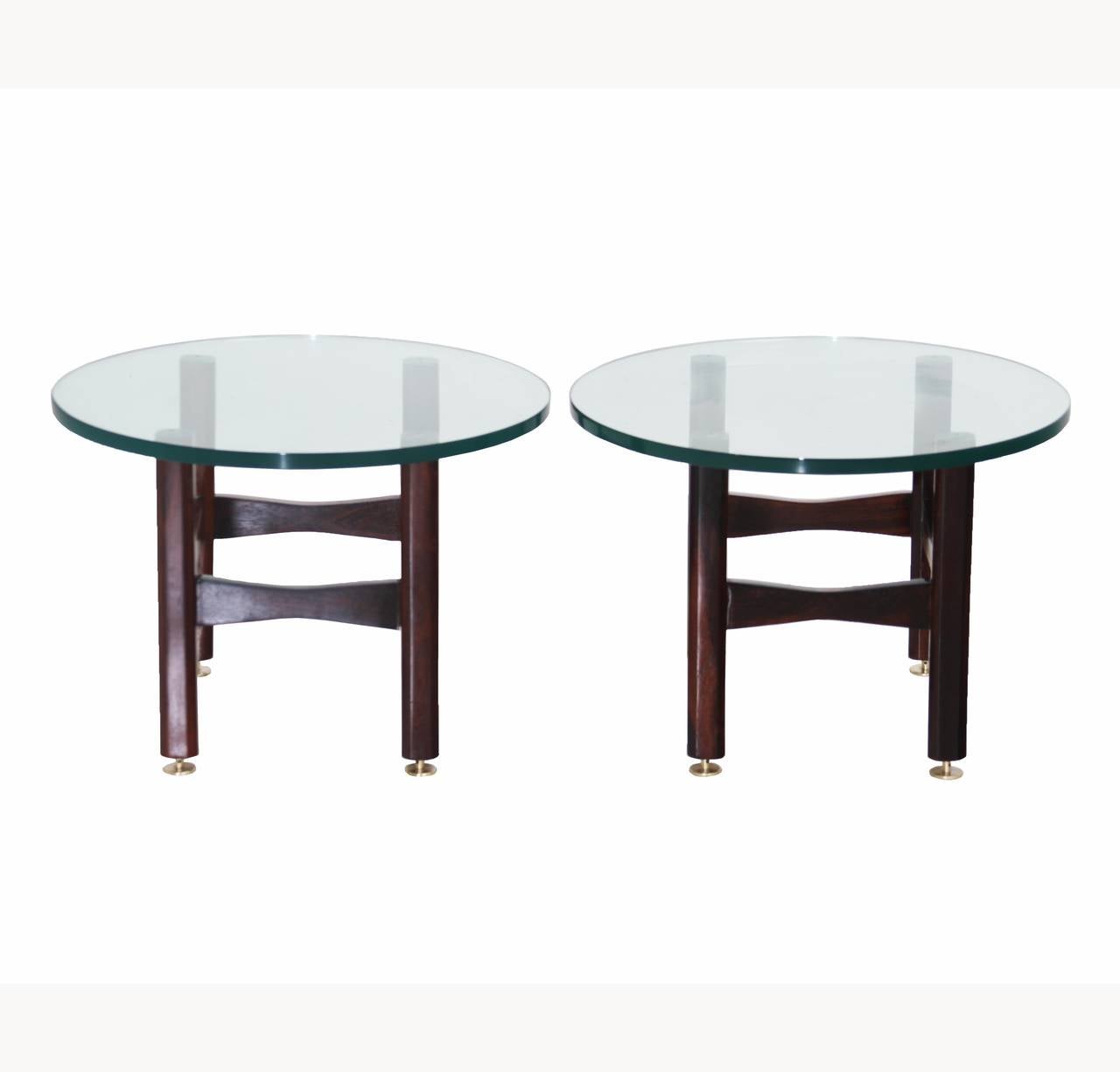 A pair of matching solid Brazilian Rosewood side tables with brushed brass feet and round clear glass tops.

Many pieces are stored in our warehouse, so please click on contact dealer under our logo below to find out if the pieces you are