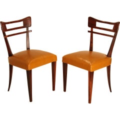 Pair of sculptural Rosewood and caramel leather side chairs