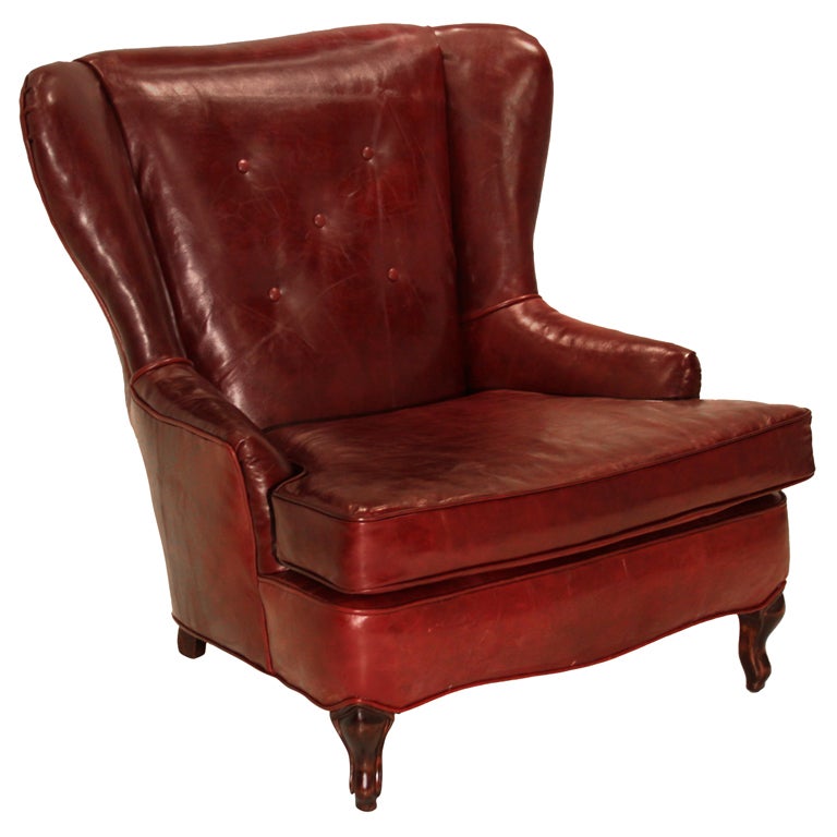 Obtuse oxblood leather and Walnut wing back chair For Sale