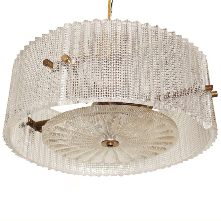 A cut glass and brass chandelier by Orrefors.

Many pieces are stored in our warehouse, so please click on CONTACT DEALER under our logo below to find out if the pieces you are interested in seeing are on the gallery floor. Thank you!