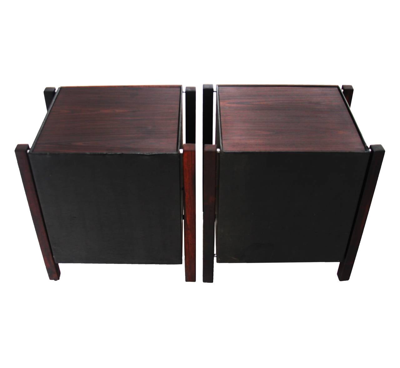 A pair of side tables designed by Brazil's Jorge Zalszupin with solid Rosewood uprights, solid Rosewood drawer fronts, Rosewood tops, original black leather wrapped cases, and chrome pulls.

Many pieces are stored in our warehouse, so please click