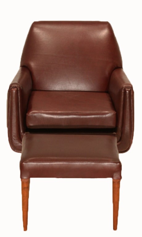 Burnt red leather armchair and ottoman with caviuna wood legs from Brazil. The ottoman measures 14.5