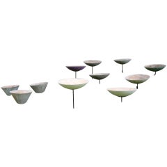 Large set of conical composite planters on stands from Brazil