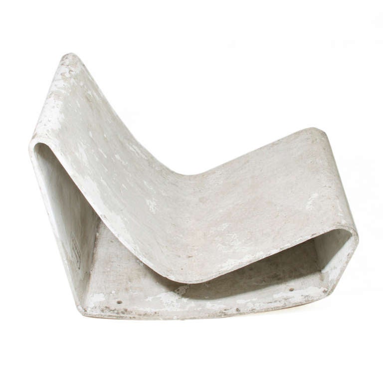 A single concrete outdoor rocking lounge chair produced by Eternit and first designed by Swiss designer Willy Guhl in 1954. Labelled 