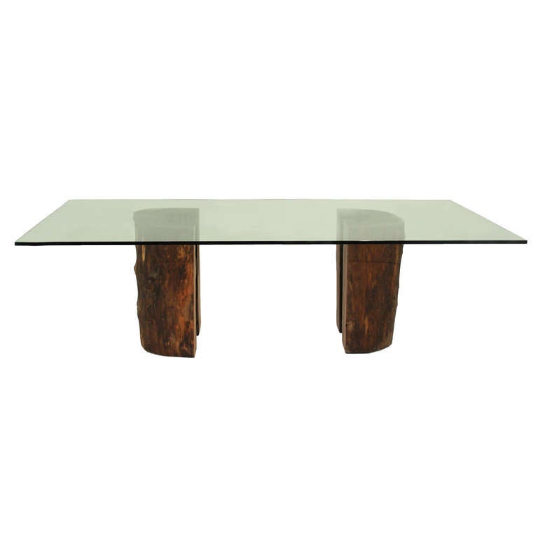 Contemporary Ipe trunk pedestal dining table with glass top by Tunico T.