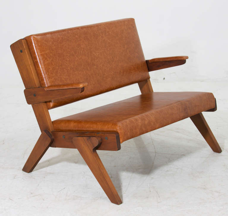 A solid Peroba de Rosa settee or bench in the style of Lina Bo Bardi upholstered in a distressed caramel colored leather. A coordinating set of chairs is also available. Many pieces are stored in our warehouse, so please click on “Contact Dealer”