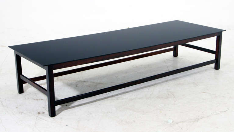 A beautiful solid Brazilian Rosewood coffee table with reverse painted black glass top. 

Many pieces are stored in our warehouse, so please click on CONTACT DEALER under our logo below to find out if the pieces you are interested in seeing are on