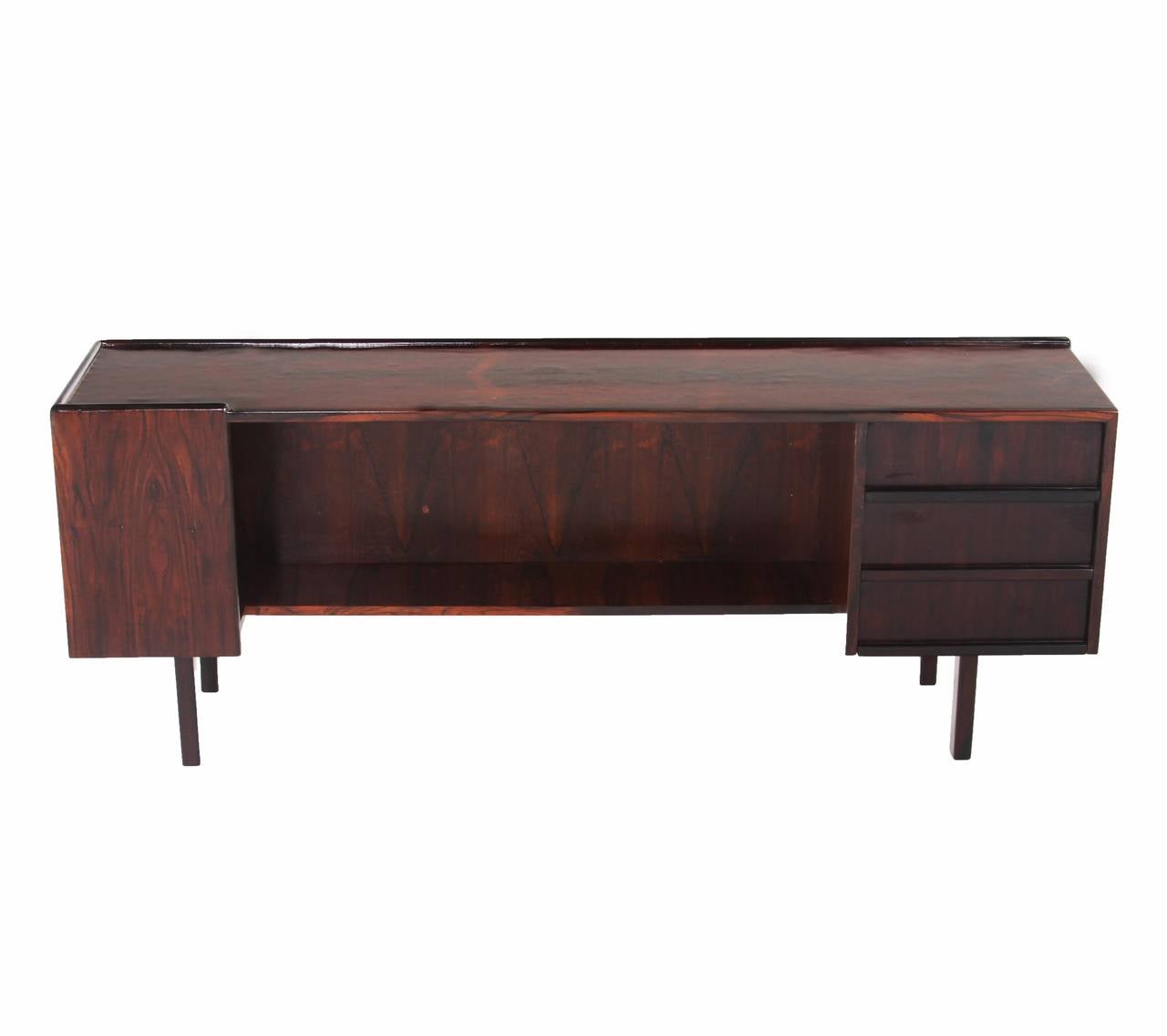 A rare Brazilian exotic hardwood credenza with four legs, one section of drawers and a storage shelf. 

Many pieces are stored in our warehouse, so please click on 