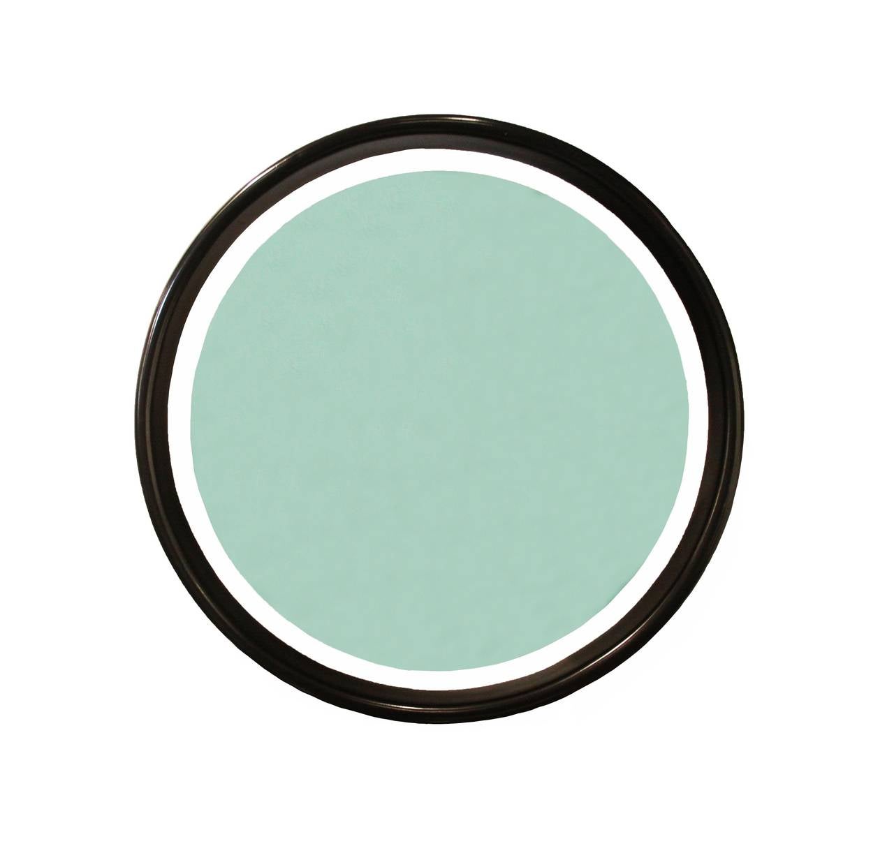 Round mirror that appears to be floating if hung on a white wall, because the backing is white finished wood. The round frame is ebonized wood with satin lacquer finish, and the tinted blue mirror is held in place with small chrome tabs. 

Many