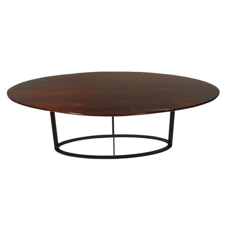 A beautifully grained vintage Rosewood oval dining table from Brazil with some visible sap grain on a new flat black finished metal oval base. The edge of the top is nicely beveled for an elegant finish.

Many pieces are stored in our warehouse,