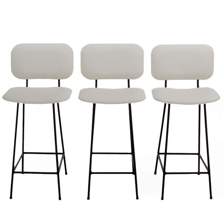 A smaller version of the Bunda Stool with slimmer solid steel frame and curved upholstered seat by Thomas Hayes Studio. 

This item is available for custom order and the lead time is 6-8 weeks; sometimes we are able to complete projects faster, so