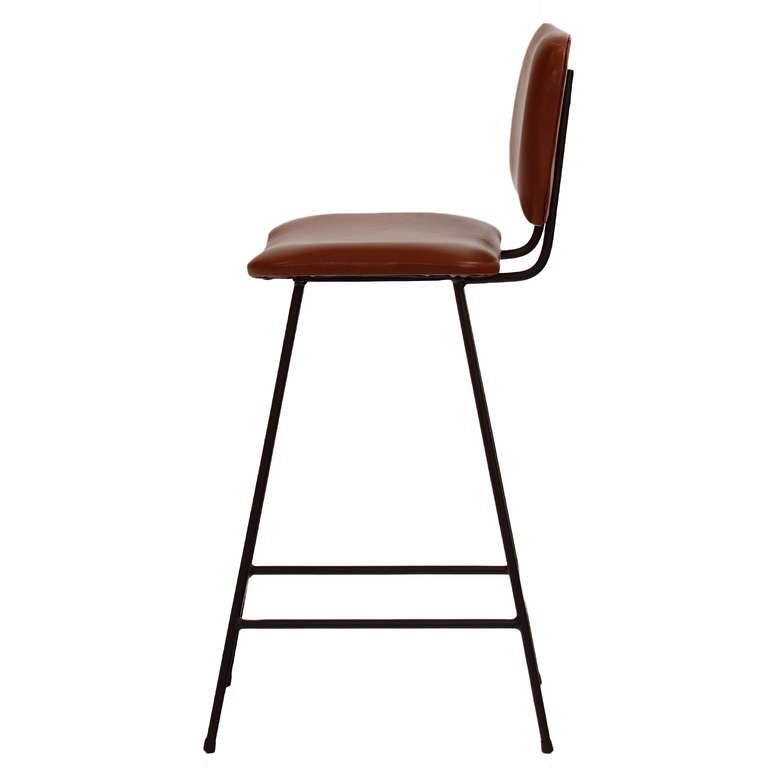 A smaller version of the Bunda Stool with slimmer solid steel frame and curved upholstered seat by Thomas Hayes Studio. 

This item is available for custom order and the lead time is 6-8 weeks; sometimes we are able to complete projects faster, so