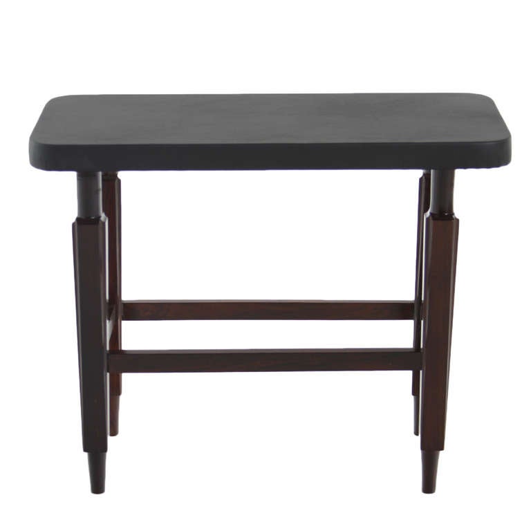 An elegant Solid Rosewood side table from Brazil with a black leather top. The legs are square with conical feet

Many pieces are stored in our warehouse, so please click on CONTACT DEALER under our logo below to find out if the pieces you are
