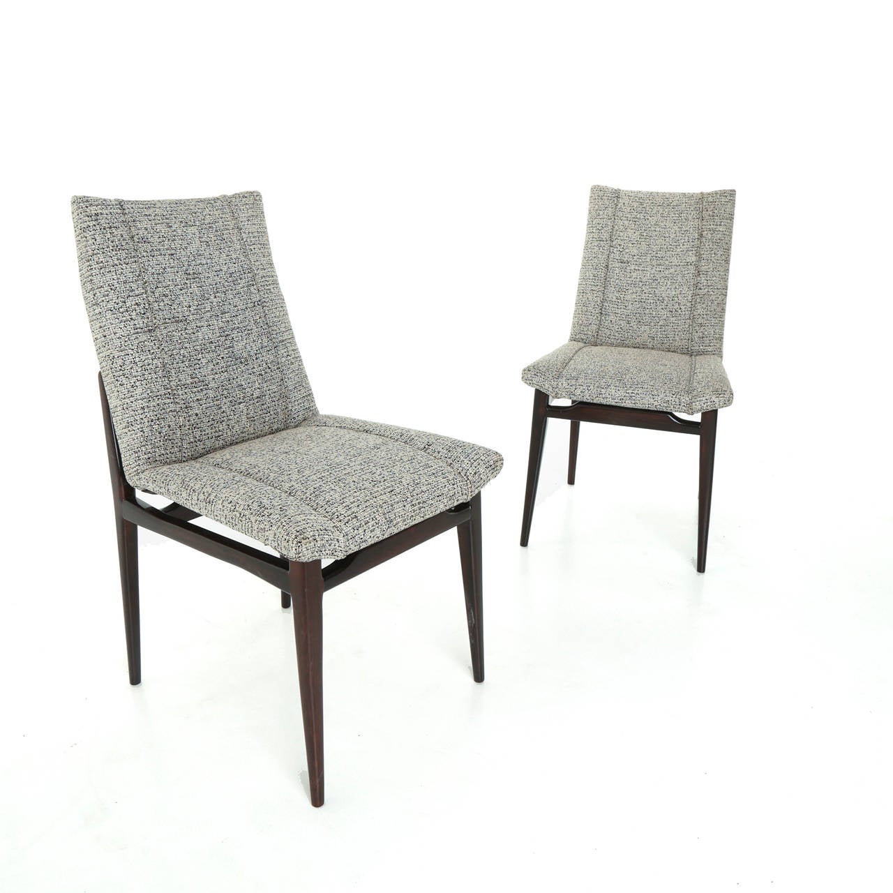Pair of sculptural wood armchairs from Brazil with gray fabric upholstery and vertical piping details.

Seat depth: 16 inches.

Many pieces are stored in our warehouse, so please click on 