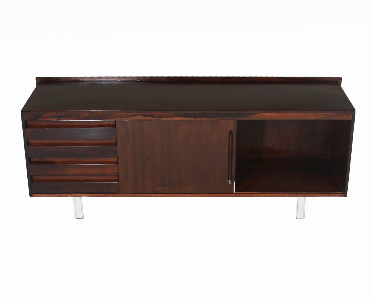 Brazilian rosewood credenza with four chrome legs, one section of drawers and a sliding door. This would be perfect for a media cabinet.

Many pieces are stored in our warehouse, so please click on 