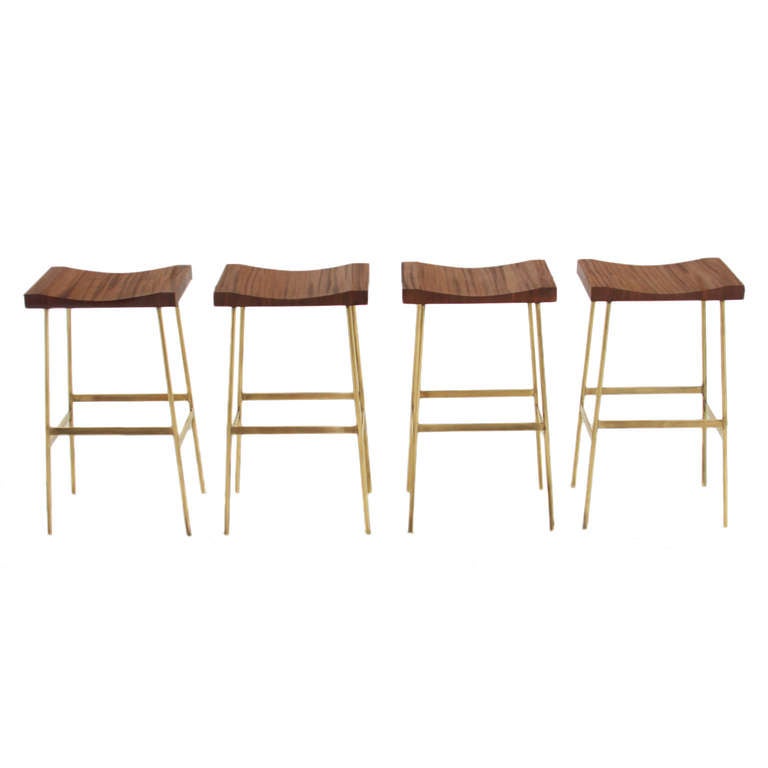 A custom version of the Bunda Bar Stool by Thomas Hayes Studio with solid brass frames and solid wood hand-carved tops. 

Please look at all pictures, as these stools are individually handmade and the solid brass has some variation. The light