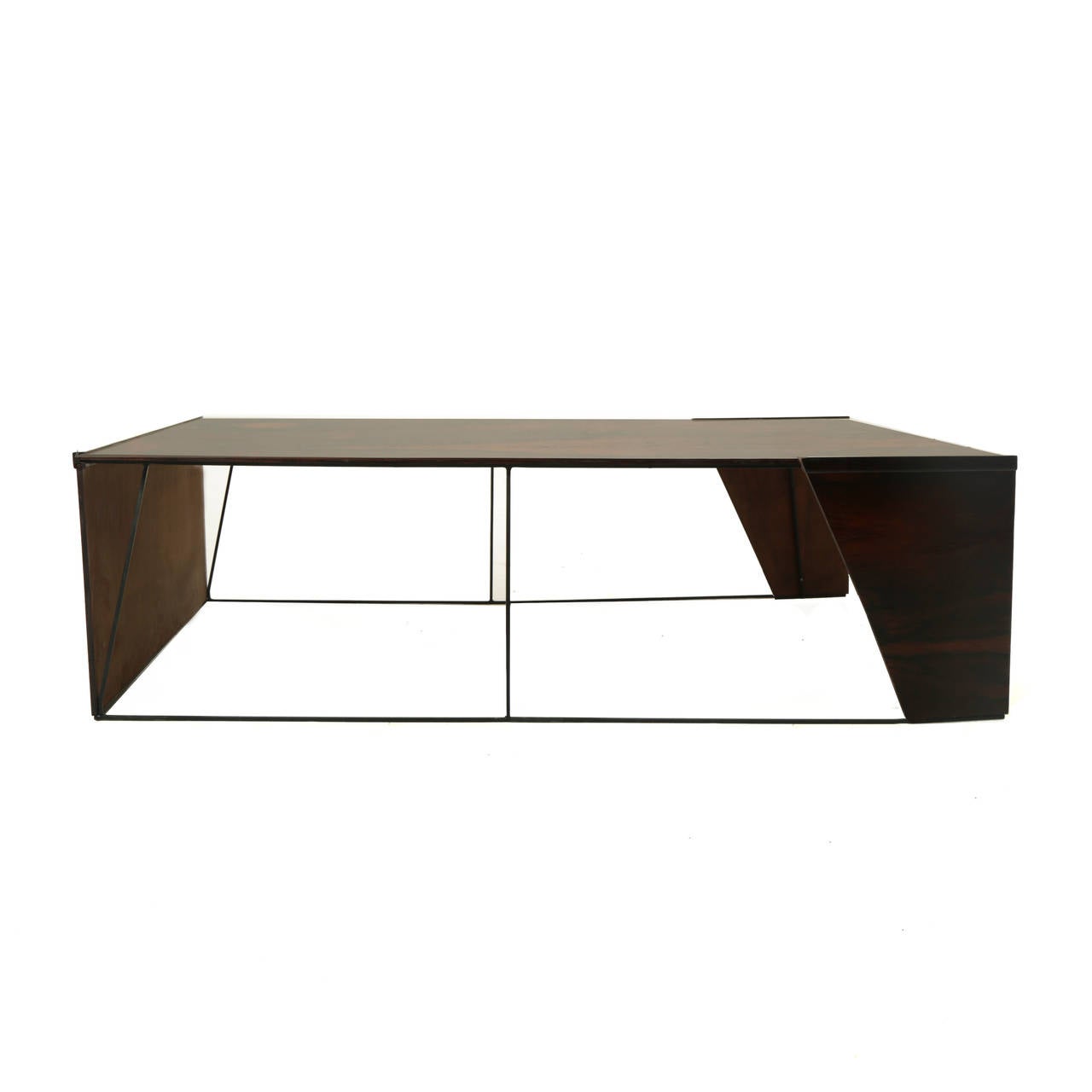 A large rectangular Rosewood coffee table from Brazil with metal stretchers. The top has open grains and figuration as the rosewood is textured as seen in pictures. The legs retain patina and grit from age, which has been hand oiled and cleaned and