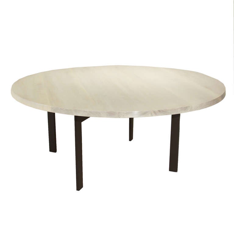 A custom round bleached Walnut dining table designed by Thomas Hayes Studio. The base is 1