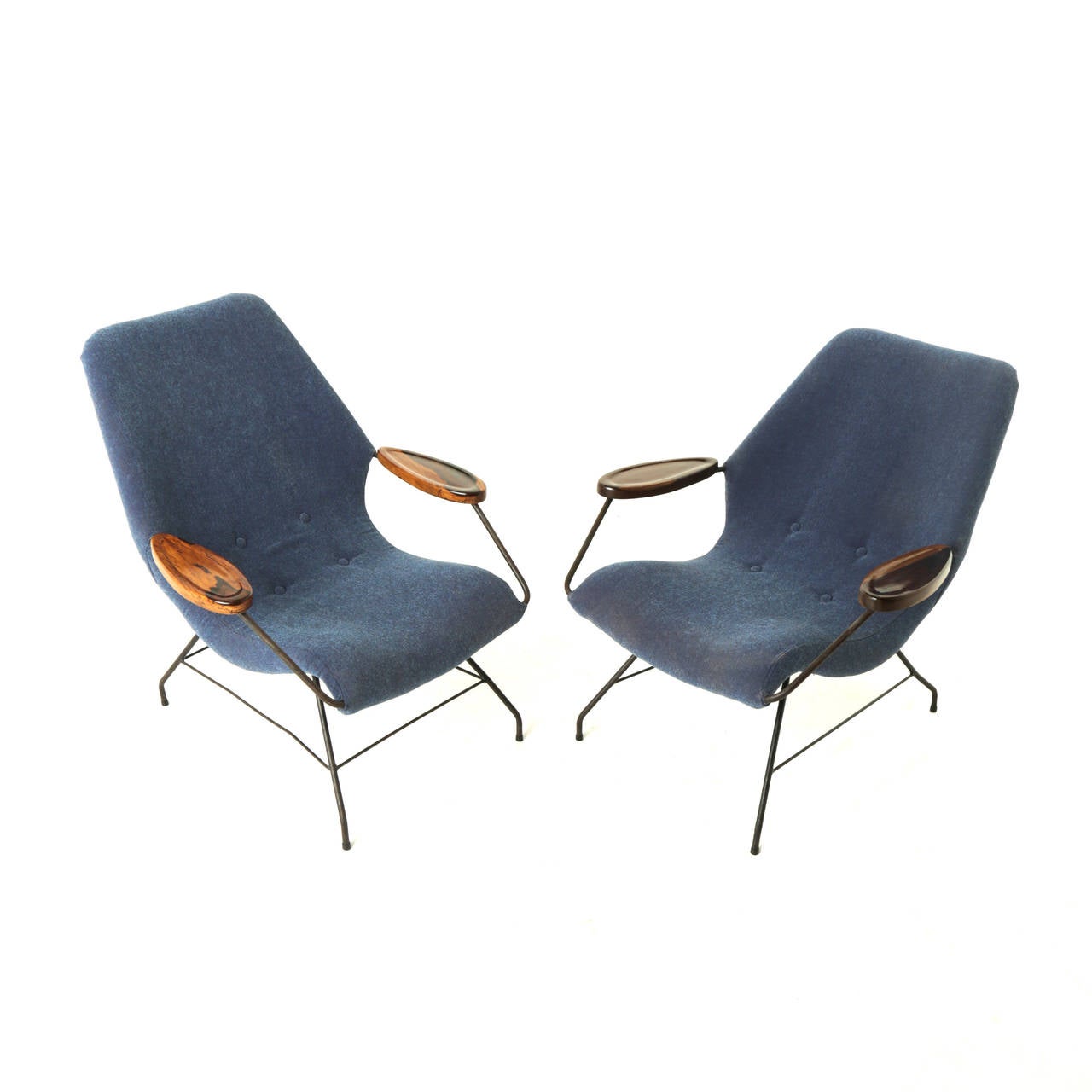 Pair of vintage Marin Eisler armchairs with thin black steel frames and solid rosewood arms with prominent sap grain. The upholstery is blue fabric. Metal shows pitting and patina consistent with age. The frames are slightly different. One frame has