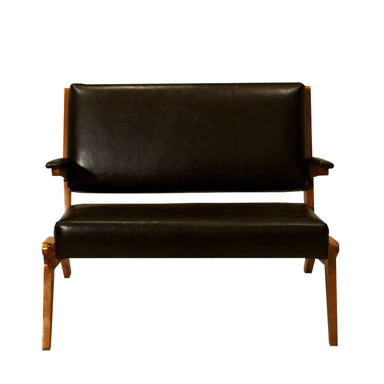 A lovely little settee in angled solid Peroba de Rosa wood and dark brown leather by Brazilian designer Lina Bo Bardi. This piece is comfortable and the finish on the wood is natural, revealing beautiful warm grain patterns and texture. 

Seat