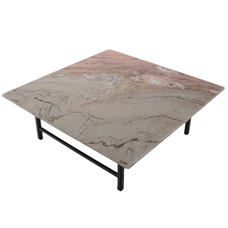 A simply elegant coffee table from Brazil in exotic dark grain wood with a natural lacquer finish. The top is a beautiful pink and grey marble. The base is a simple design with four conical legs. Two of the outer legs have a piece of wood bar