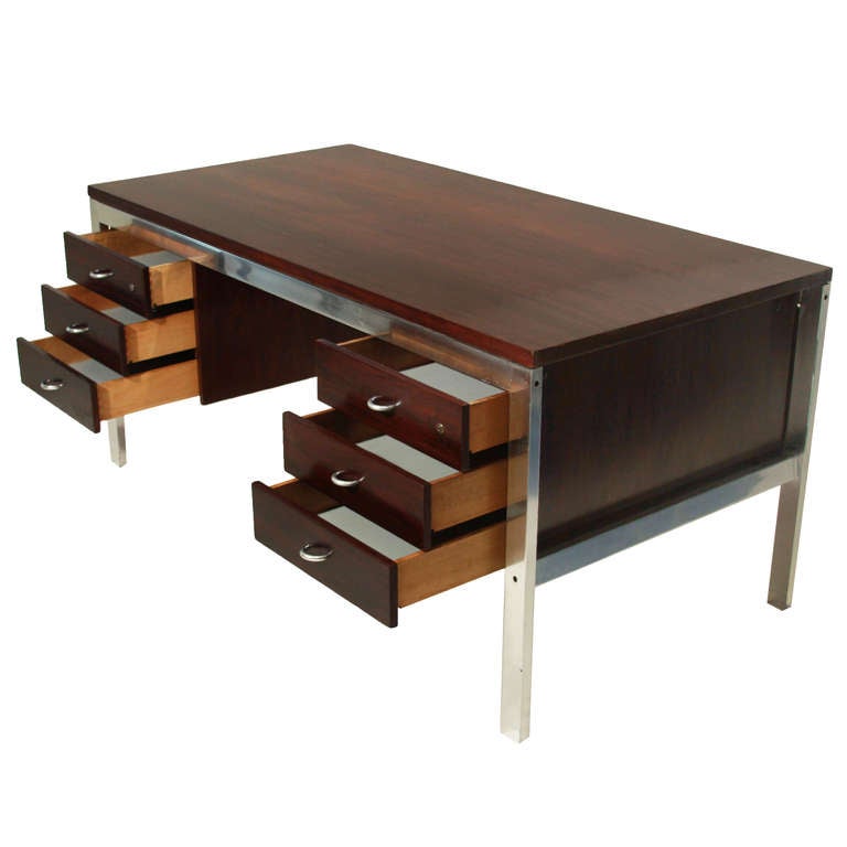 A vintage rosewood and aluminum desk frame desk with two sets of drawers with half-circle chrome pulls. 

Many pieces are stored in our warehouse, so please click on 