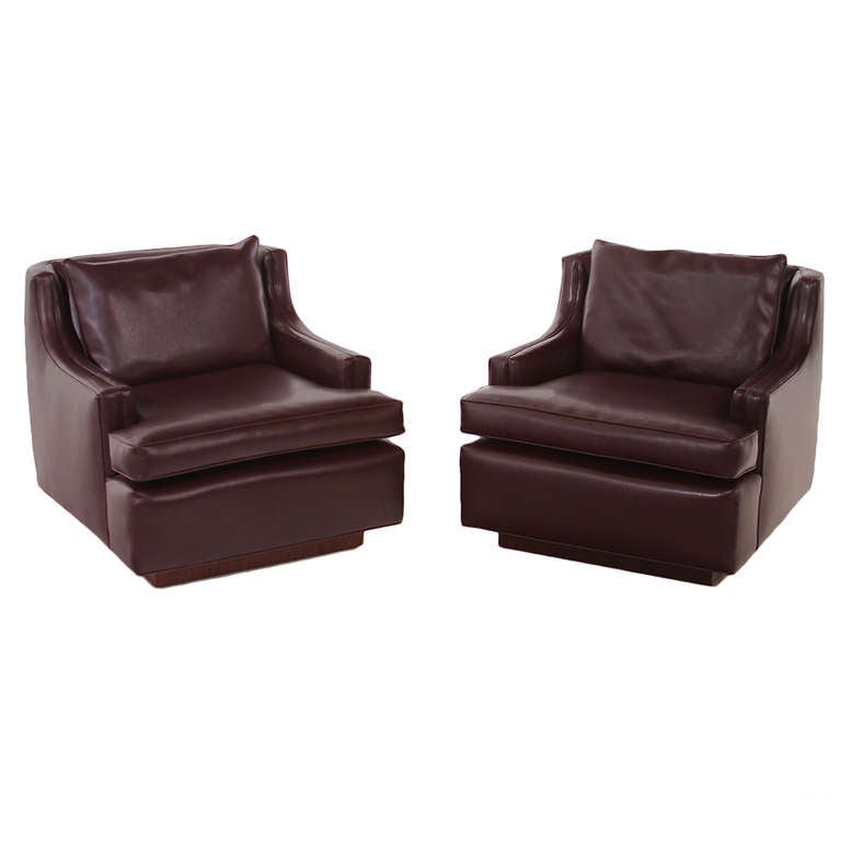 A beautiful pair of maroon leather lounge chairs with a solid walnut inset square base. 

Seat depth 21.5

Many pieces are stored in our warehouse, so please click on 