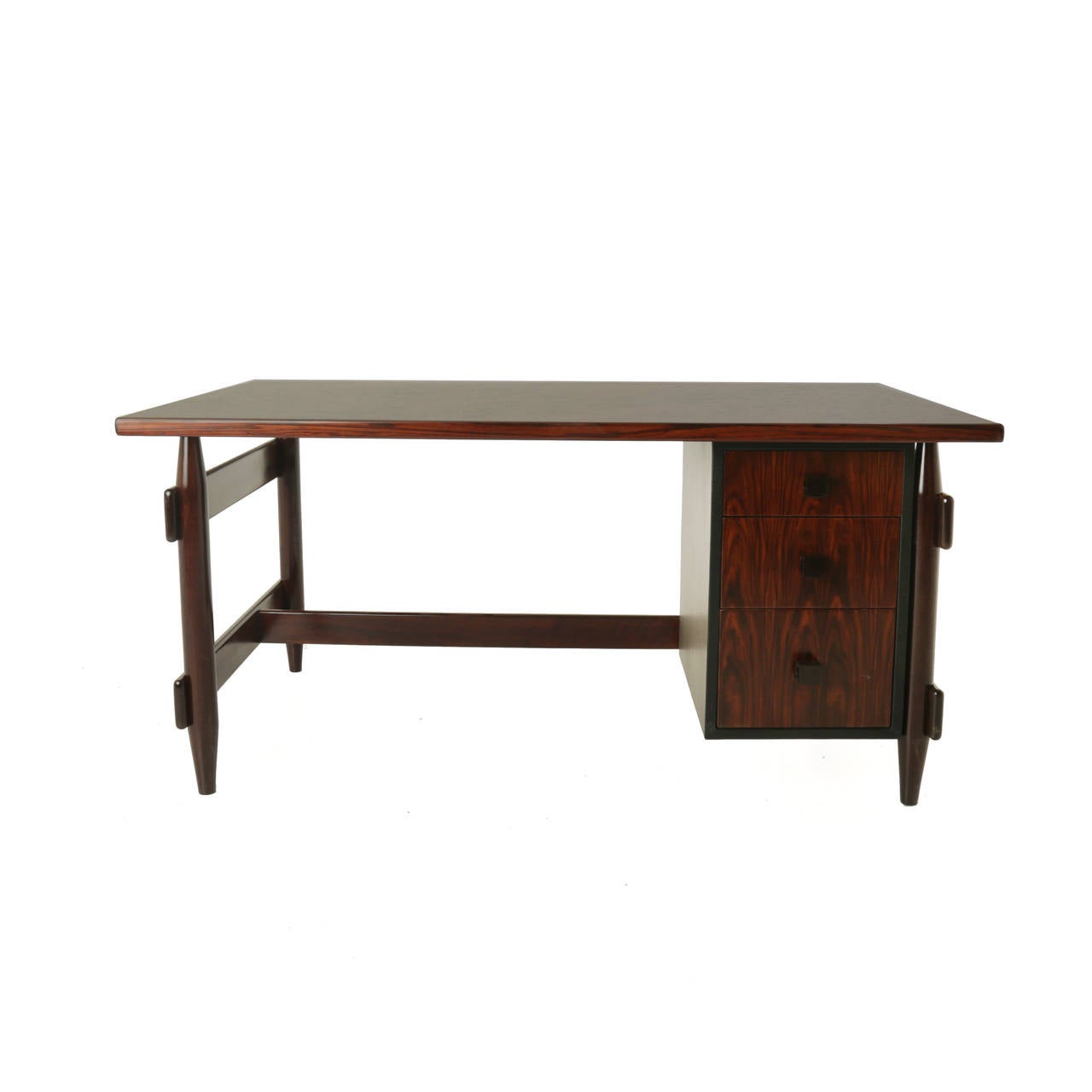 Solid rosewood desk from Brazil with tapered legs and three drawers for storage. The handles are solid wood as well. 

 