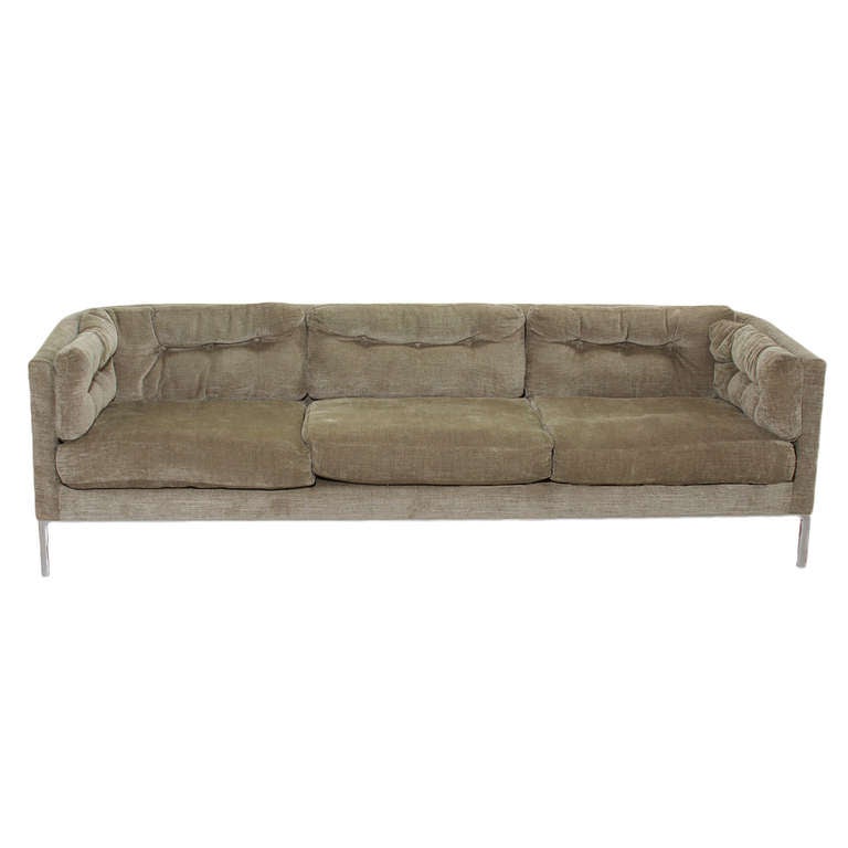 A lovely Dunbar sofa with curved back to arm junctions upholstered in a pale olive green chenille fabric on a stainless steel base. 

Seat Depth 23.5