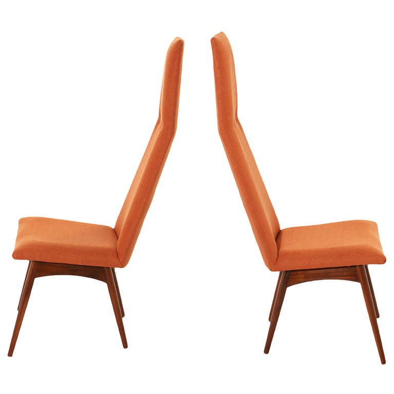 A pair of lovely high back side chairs with uniquely shaped high backs with button tufts in the burnt orange linen upholstery on top of solid wood sculptural splayed legs. 

Many pieces are stored in our warehouse, so please click on CONTACT